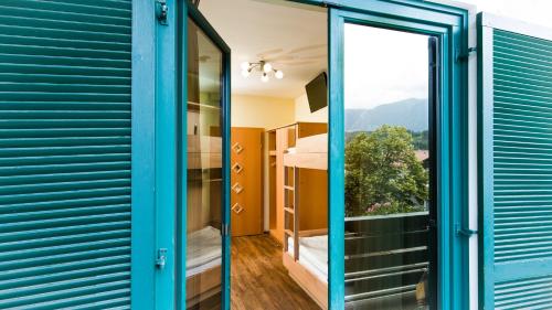 a room with a blue door and a window at Familiengut Ertlhof in Seeboden