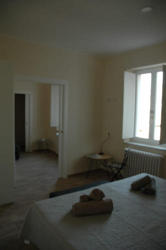 a bedroom with a bed with two towels on it at Via Barocci 34 in Urbino