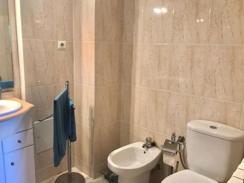 a bathroom with a toilet and a sink at Casa Praia Ofir in Esposende