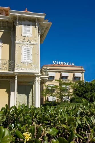 a building with a sign on the side of it at Hotel Vittoria in Pesaro