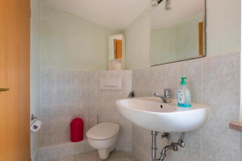 a bathroom with a sink and a toilet at Casa Vista mare Bosa/Magomadas in Magomadas