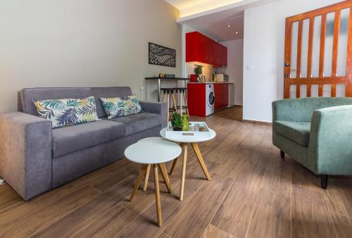 a living room with a couch and two chairs and a table at Summer Home by the Beach in Kato Daratso