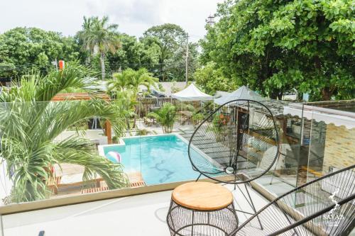 a balcony with a swing and a swimming pool at Sayab in Playa del Carmen