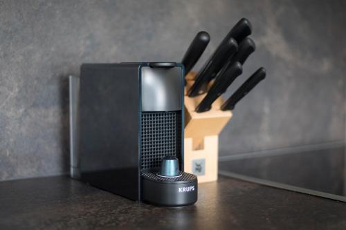 a knife block sitting on top of a counter with a block of knives at Wagner's Aparthotel in Pertisau