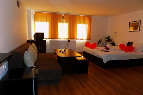 a hotel room with two beds and a couch at Yakovtsi Inn in Yakovtsi