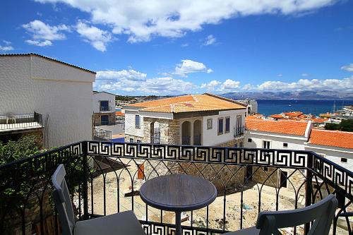 a balcony with a table and a view of the ocean at Çeşme Kale Taş Apart in Cesme