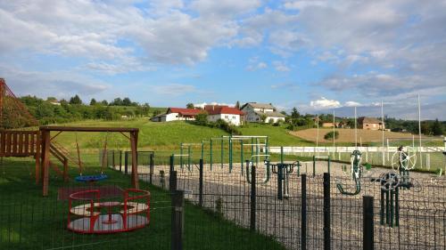 a park with a playground in a field at Holiday Home Rojko in Štrigova