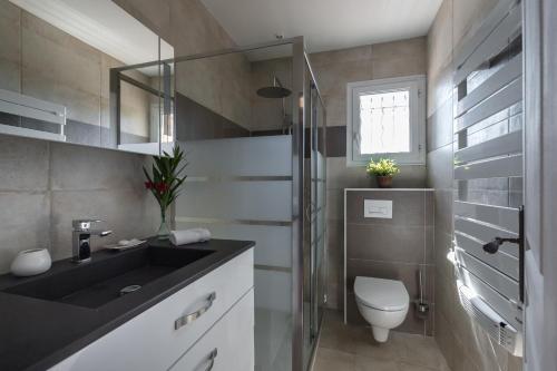 a bathroom with a sink and a toilet in it at Sleep In Biot in Biot