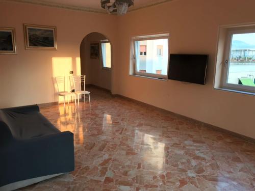 a living room with a couch and a flat screen tv at Vient e mare (Sea wind) in Torre Annunziata