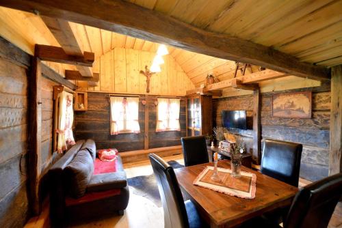 a living room with a wooden table and a couch at Grebengradska Medna Hiža in Donje Makojišće