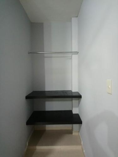 a walk in closet with black shelves on the wall at Hotel Popeye in Ciudad Valles