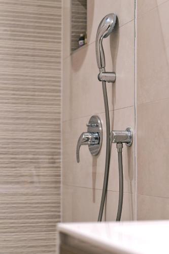 a shower in a bathroom with a shower head at Apartment Luce in Njivice