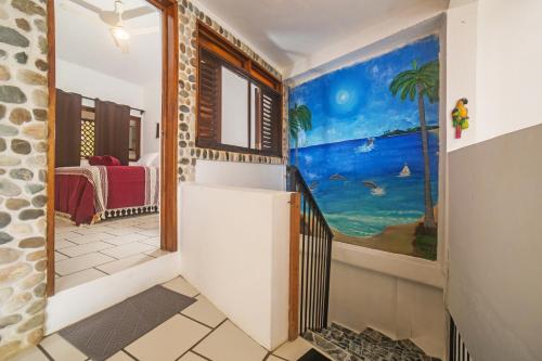 a hallway with a painting on the wall at Casa Lucas in Sayulita