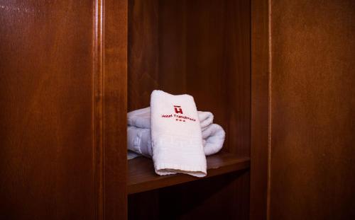 a towel is sitting on a shelf in a closet at Hotel Transilvania in Cluj-Napoca