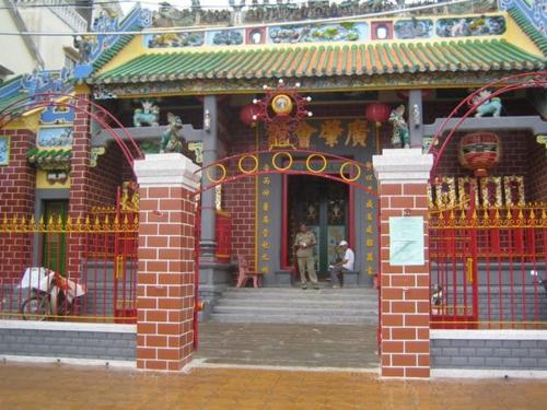 a building with a gate in front of a temple at BangBang Motel in Can Tho