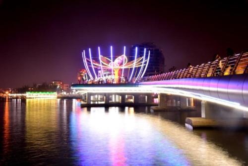 a bridge over a body of water at night at BangBang Motel in Can Tho