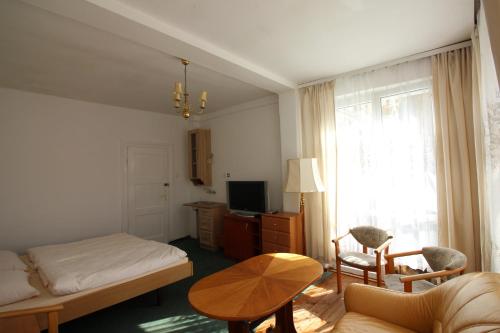 米茲多洛傑的住宿－Dom wypoczynkowy Szarotka&Krokus，一间卧室配有一张床、一张桌子和一个窗户。