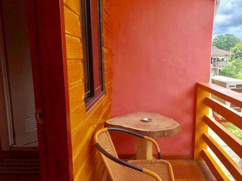 a table and chairs on a balcony with a window at Michelina Princess Guest House in Loboc