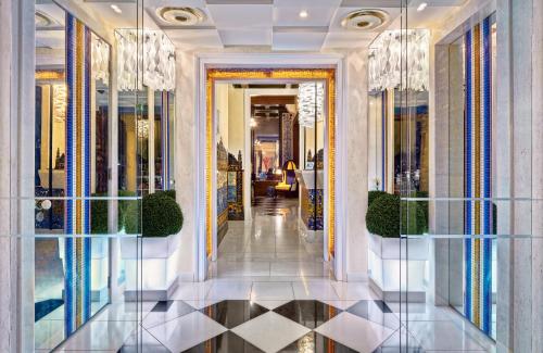 a hallway of a hotel with a lobby with chandeliers at Bela Vista Hotel & Spa - Relais & Chateaux in Portimão