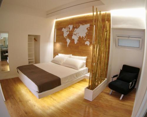 a bedroom with a large bed and a chair at Ragusa 2 al mare in Marina di Ragusa