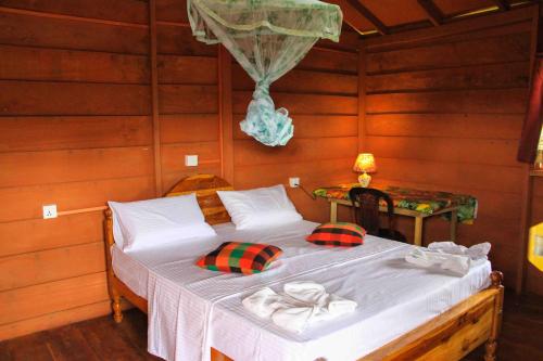 a bedroom with a bed in a wooden room at Sigiri Royal Point Tree House in Sigiriya