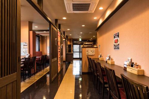 a dining room with a long table and chairs at Hotel Wing International Kumamoto Yatsushiro in Yatsushiro