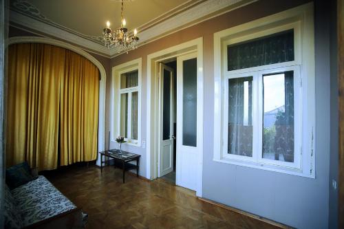 a living room with a chandelier and a window at Guest House Old Kutaisi in Kutaisi