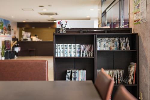 a book shelf full of dvds in a library at Hotel Wing International Kumamoto Yatsushiro in Yatsushiro