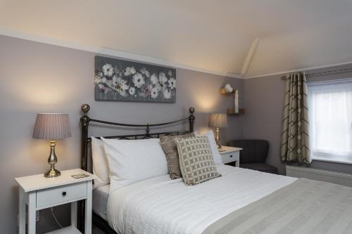 sypialnia z łóżkiem, 2 stołami i oknem w obiekcie Brockhurst Lodge w mieście Gosport