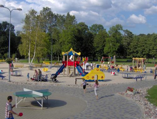 a group of children playing in a playground at Veranda Suite in Liepāja