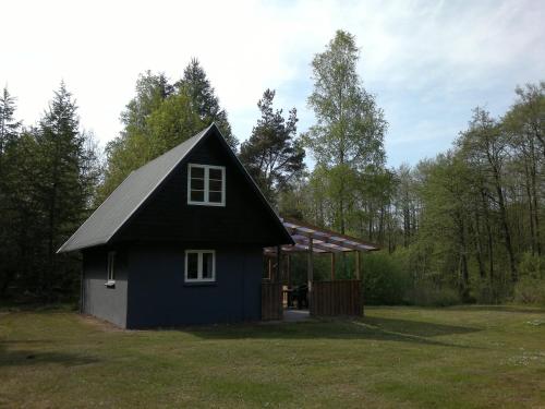 a blue house with a gazebo in a yard at Nix at Gammel Rye in Ry