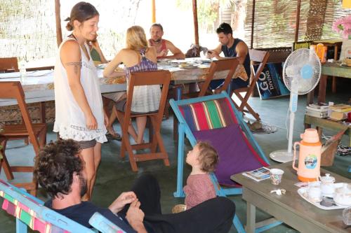 a group of people sitting at a table in a room at Sun Wind Beach Kalpitiya Kite Resort in Kalpitiya