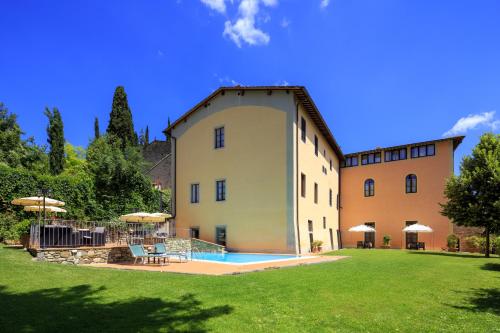 a large building with a swimming pool in a yard at Antico Pastificio in Greve in Chianti