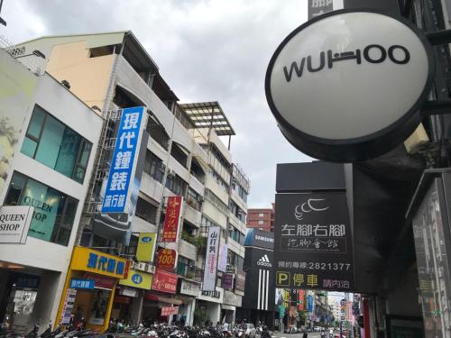 a street in a city with many signs at Wuhoo House in Kaohsiung