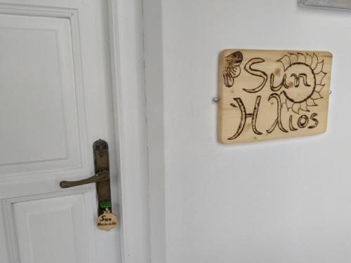 a door with a sign that says sun divides at Amaranthos Skiathos View in Megali Ammos