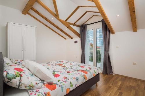 a bedroom with a bed and a window at Otium in Kaštela
