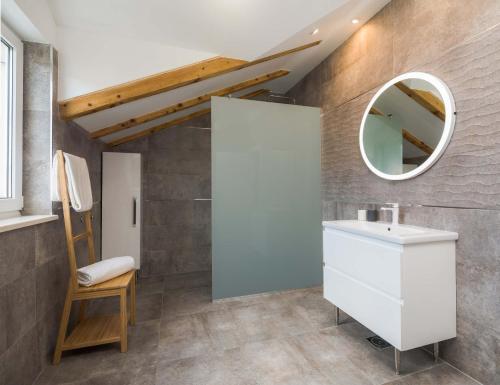 a bathroom with a sink and a mirror at Otium in Kaštela