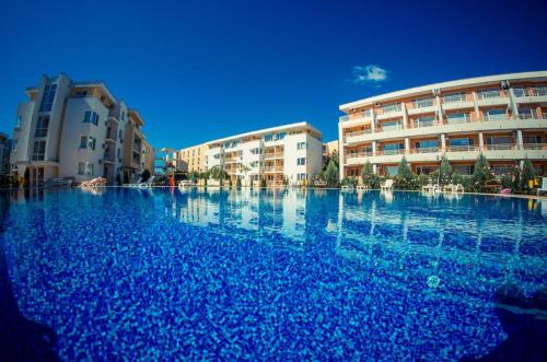 una gran piscina de agua azul frente a los edificios en Apartment in Nessebar Fort Club, en Sunny Beach