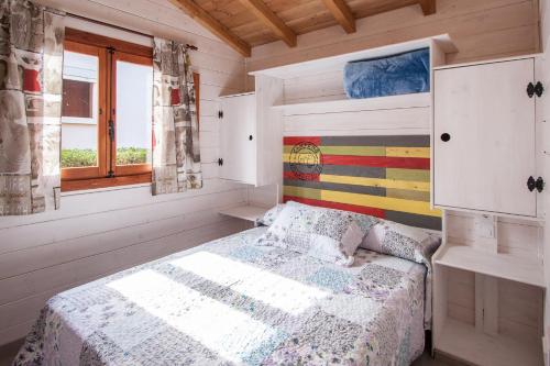 a bedroom with a bed in a wooden room at Camping Villaviciosa in La Rasa Selorio