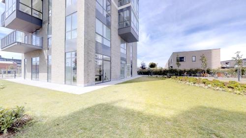 an apartment building with a lawn in front of it at The Beach apartments by Daniel&Jacob's in Copenhagen