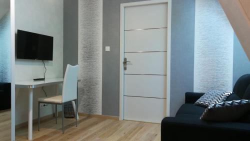 Habitación con escritorio y puerta con ordenador. en Domaine du Carouge en Lirey