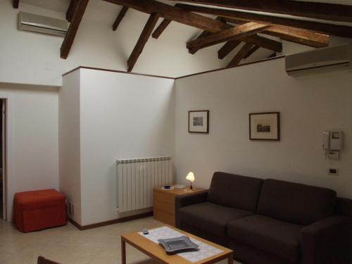 a living room with a couch and a table at Residence Al Granzo in Trieste