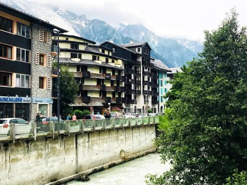 a bridge over a river in a city with buildings at Rocky Studio Chamonix Sud in Chamonix-Mont-Blanc