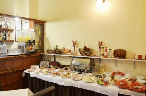 a table with plates of food on it at Hotel Transilvania in Cluj-Napoca