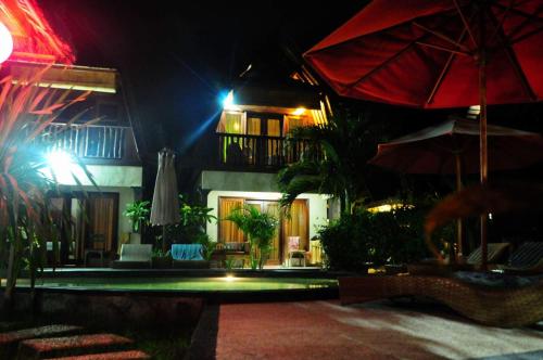 a resort with a swimming pool at night at Gili Flush Harmony in Gili Trawangan