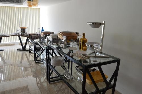 a glass table with many items on it in a room at Vivid A Boutique Hotel in Tiruchchirāppalli