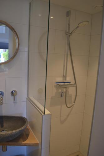 a bathroom with a shower and a sink at Behind the Beach in Zandvoort