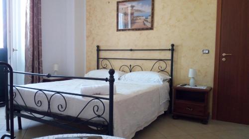 a bedroom with a black bed and a night stand at Annabella's Country House in SantʼAntonio Abate