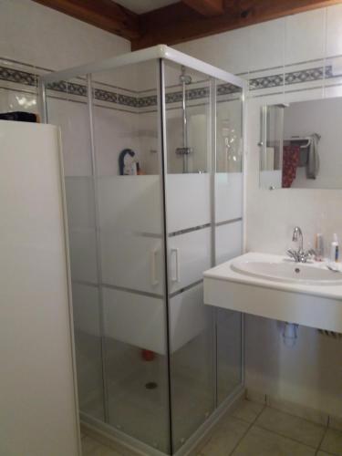 une salle de bain blanche avec un lavabo et une douche dans l'établissement Village Océlandes, à Saint-Julien-en-Born