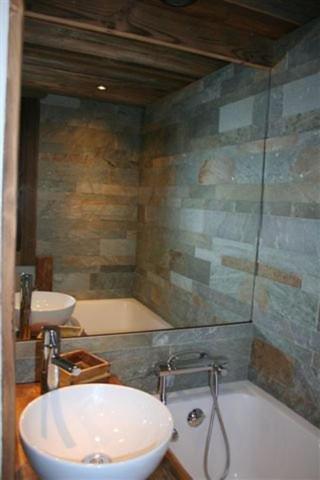 a bathroom with a sink and a bath tub at Appartement du Petit Bois in Megève